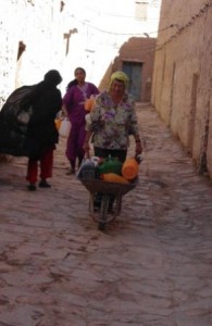 Mary pushes wheelbarrow
