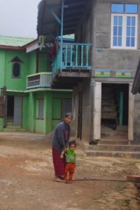A grand new house. Elderly woman with grandchild