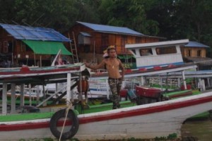 Sunset River Cruise. Boat boy showing off