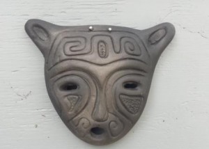 Black ceramic mask on the shed